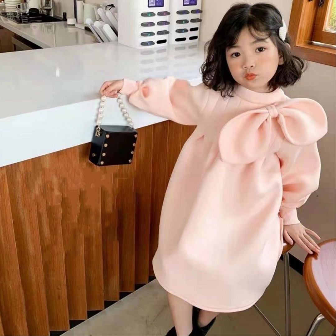 Full view of a baby girl's pink vintage party dress with ruched bodice and sleeve details