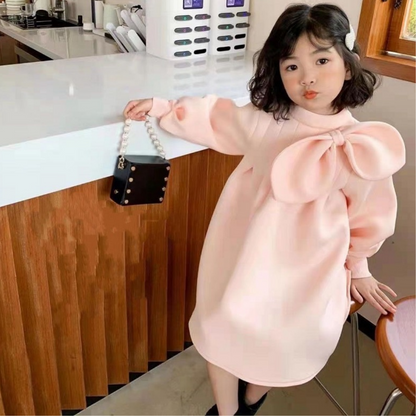 Full view of a baby girl's pink vintage party dress with ruched bodice and sleeve details