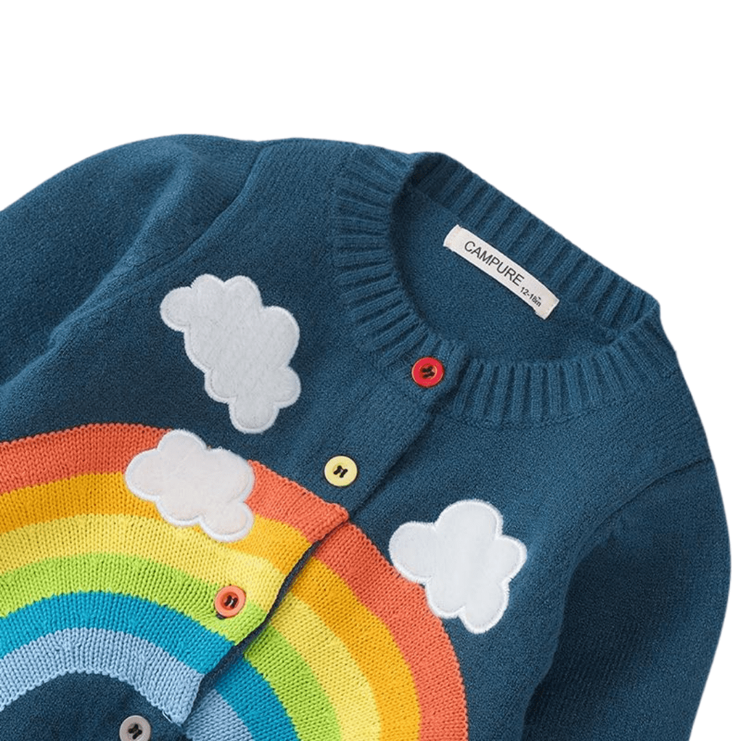 Toddler girl wearing a cozy rainbow cloud knitted cardigan, perfect as children's outerwear.