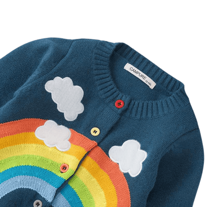Toddler girl wearing a cozy rainbow cloud knitted cardigan, perfect as children's outerwear.