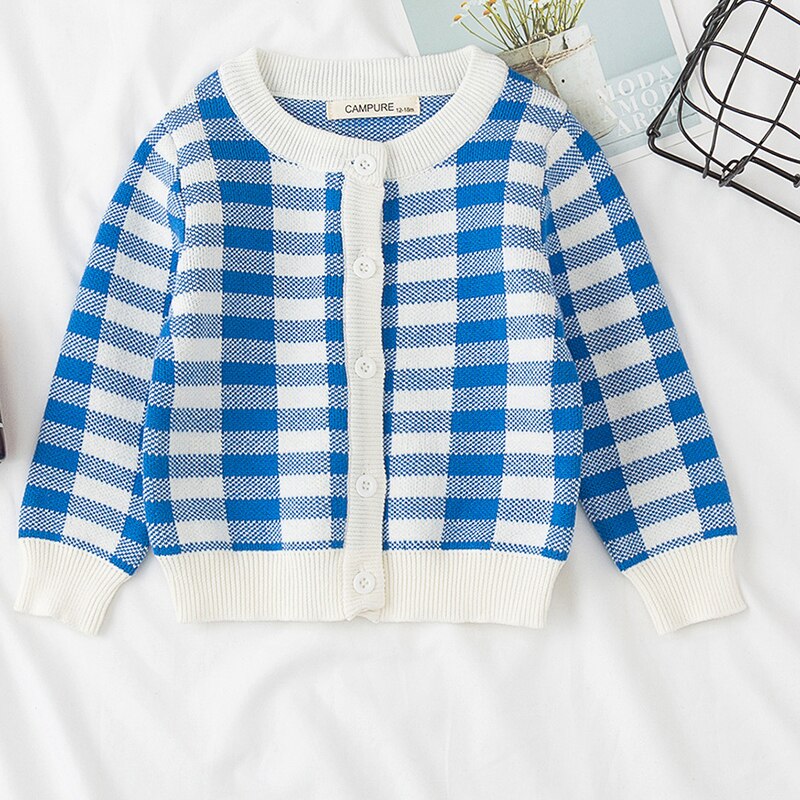 Detail of the buttons on the rainbow cloud knitted cardigan, functional and adorable for kids.