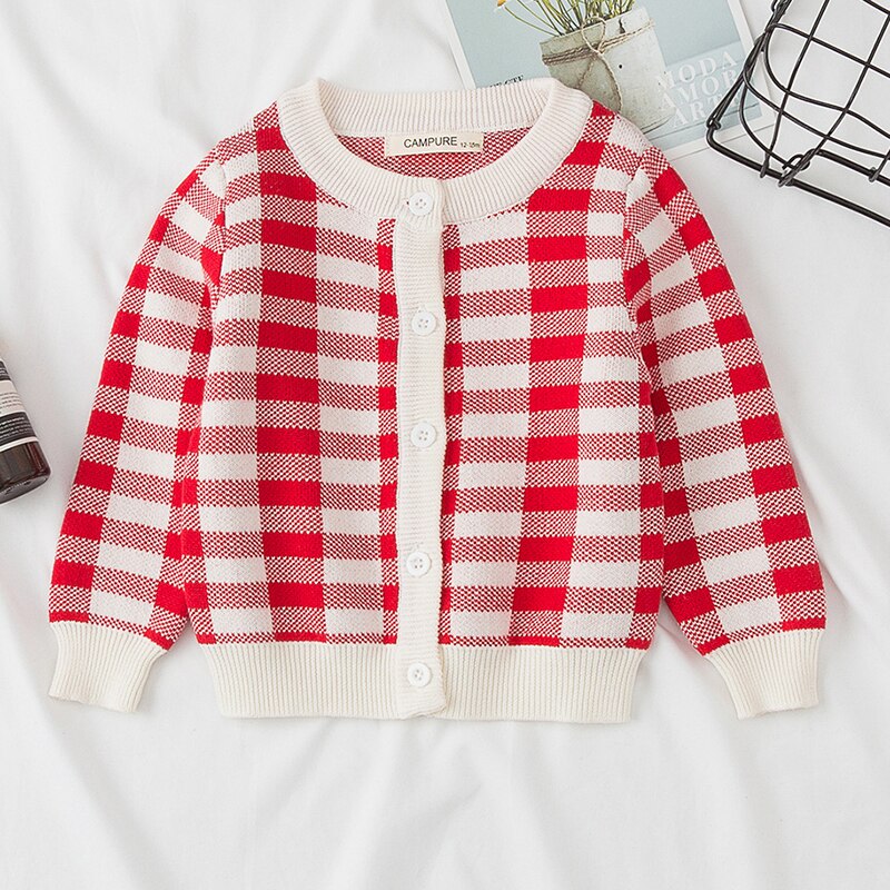 Fabric texture close-up of girls' knitted rainbow cardigan, soft cotton blend for comfort.