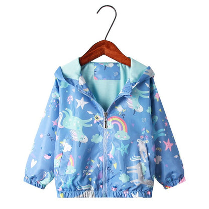 Detail shot of the unicorn motif on a girls' rainbow windbreaker jacket, kids playwear appeal