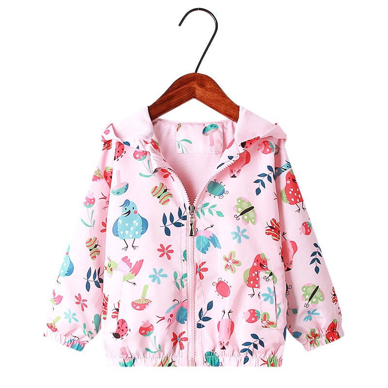 Young girl running outdoors wearing a vibrant rainbow unicorn hooded jacket, childrens outerwear