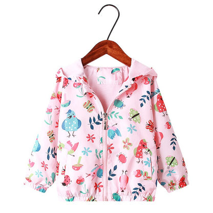 Young girl running outdoors wearing a vibrant rainbow unicorn hooded jacket, childrens outerwear