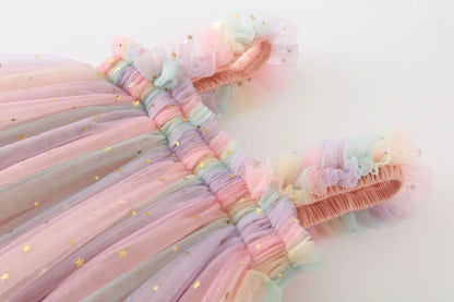 Vibrant rainbow unicorn dress for girls, featuring a soft tulle overlay and comfortable fit.