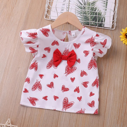 Close-up of heart print detail on girls' red summer top and matching shorts set