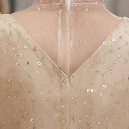 Back view of a girls' A-line puff sleeve formal gown with sequin top, ideal for flower girl