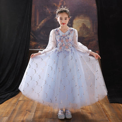 Toddler girl modeling a beautiful sequin puff sleeve A-line gown for a special occasion