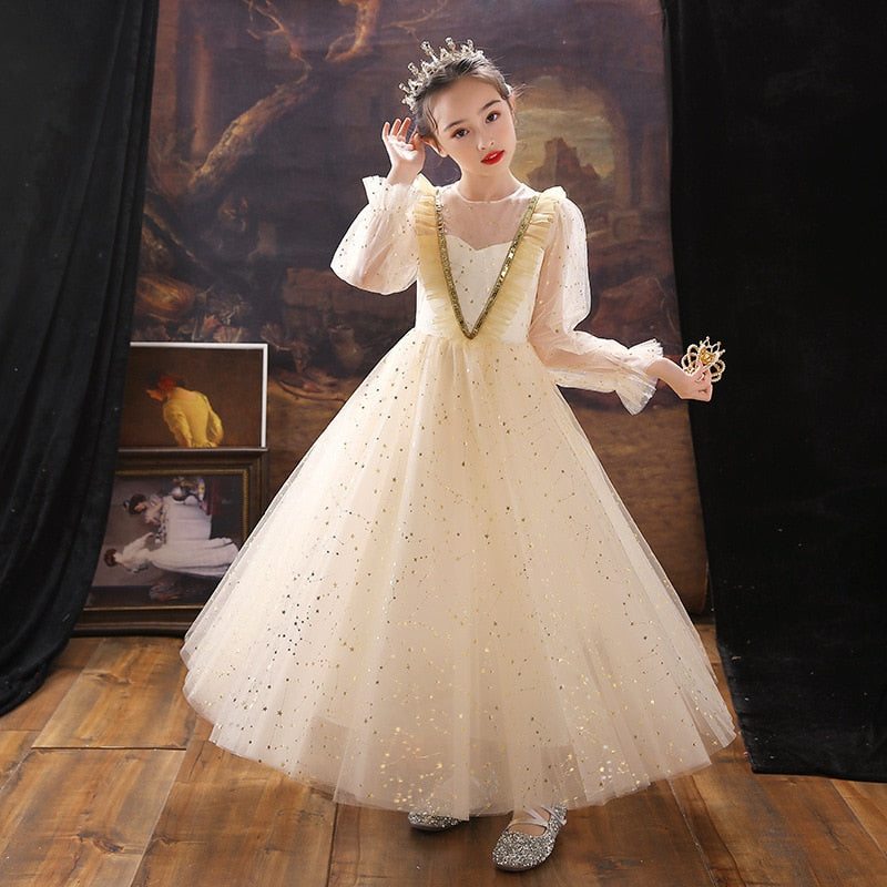 Studio shot of a girls' pink sequin puff sleeve long dress, a stunning kids party outfit