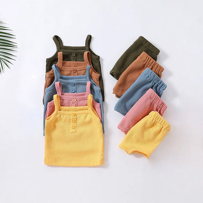 Girls' sleeveless cotton top and shorts set in pink, perfect for summer playwear