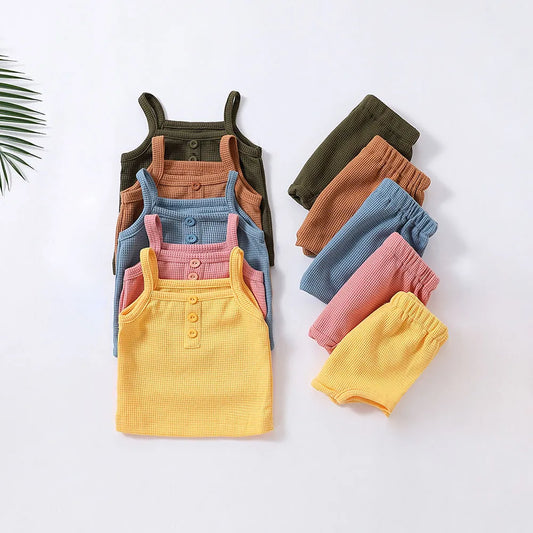 Girls' sleeveless cotton top and shorts set in pink, perfect for summer playwear