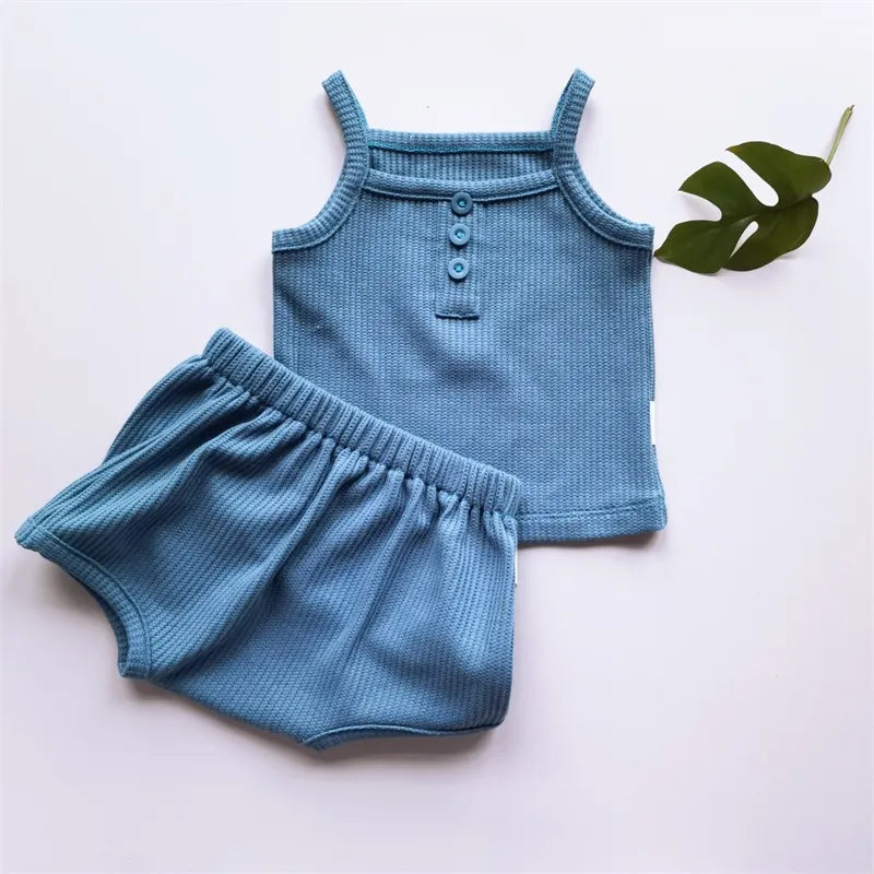 Flat lay of a girls' lightweight cotton sleeveless top and shorts set, ideal for toddlers
