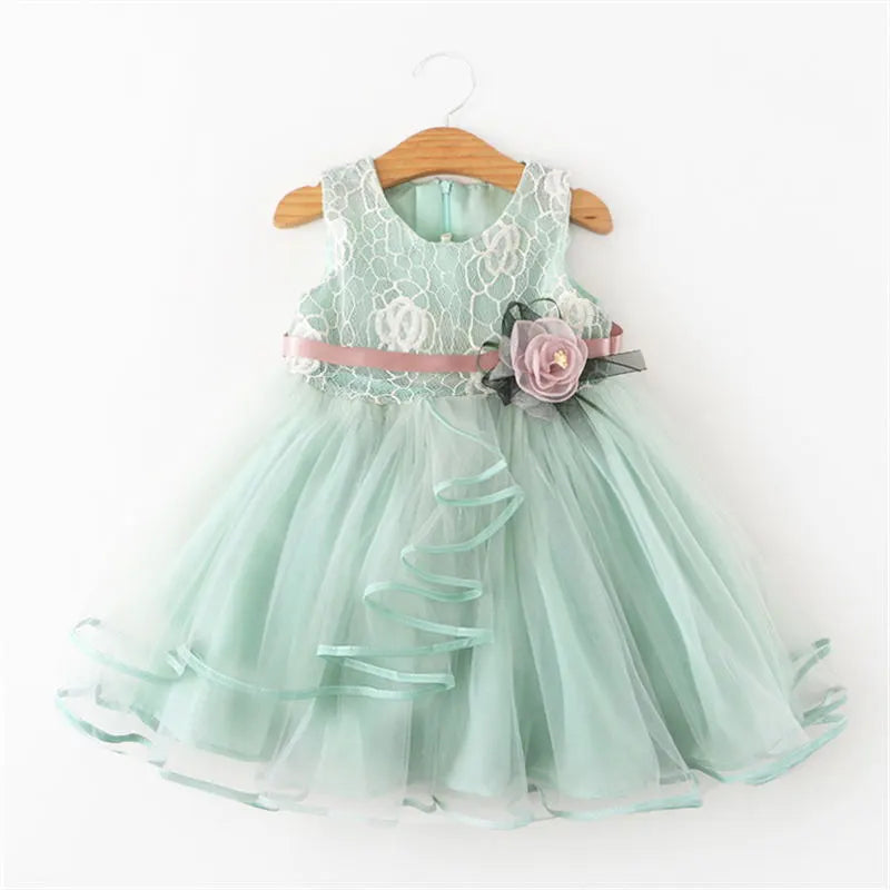 Young girl twirling in a beautiful floral sleeveless tutu dress.