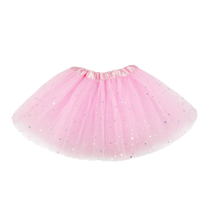 Close-up of sparkling girls' tutu skirt fabric in pink, showing glitter detail & soft mesh layers