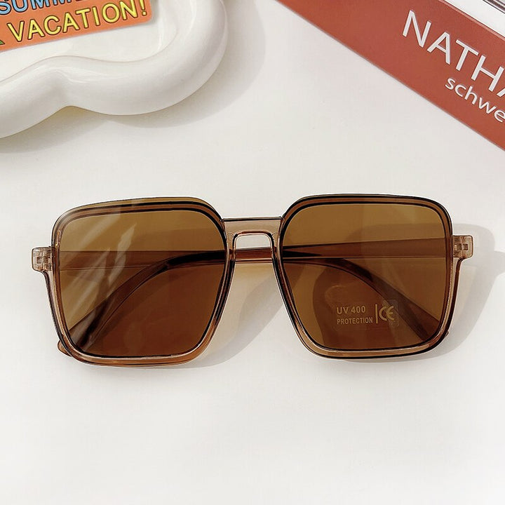 Rectangle geometric girls' sunglasses, a fashionable kids eyewear choice with UV protection.