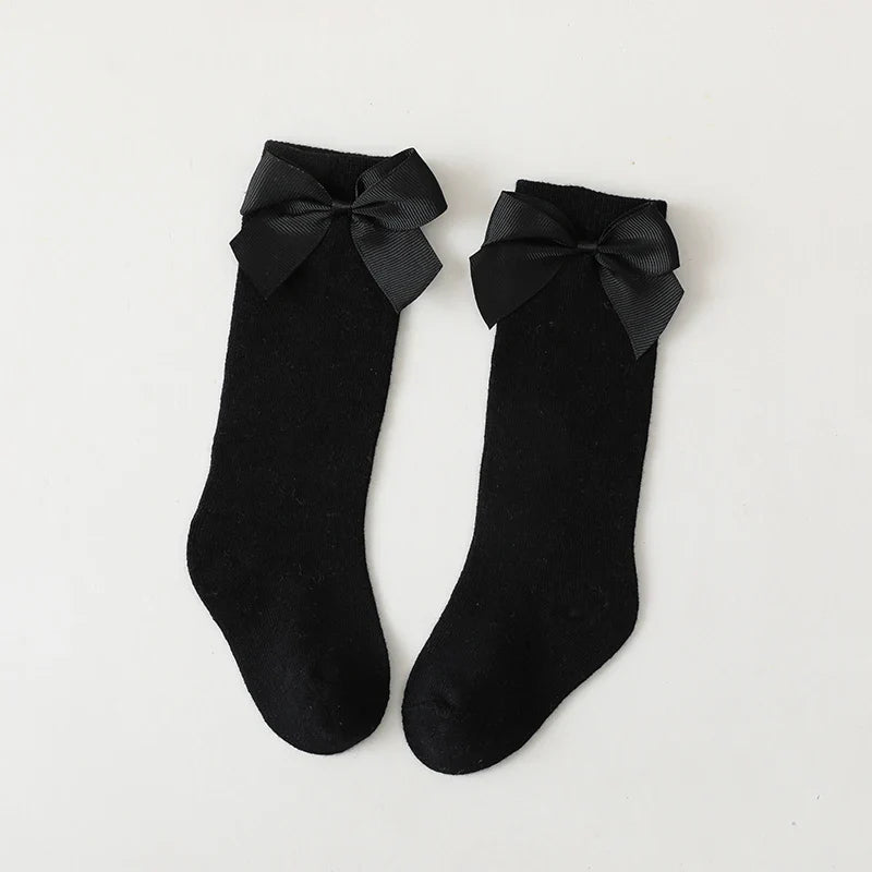 Girls' grey cotton knee-high bow socks; versatile children's apparel accessory