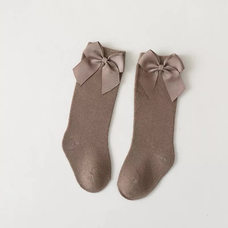 Girls' black cotton knee-high bow socks; classic children's apparel accessory