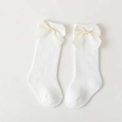 Detail shot of the mesh knit on girls' cotton knee-high bow socks; breathable summer wear