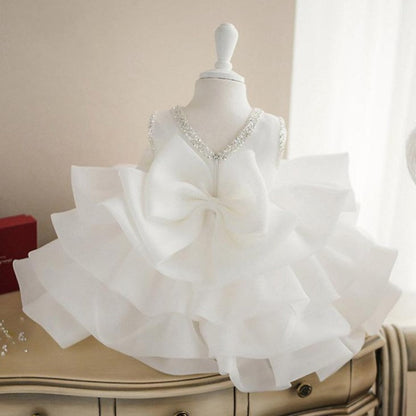 Toddler girl in a beautiful sleeveless white lace and tulle dress, ideal for parties and formal events.
