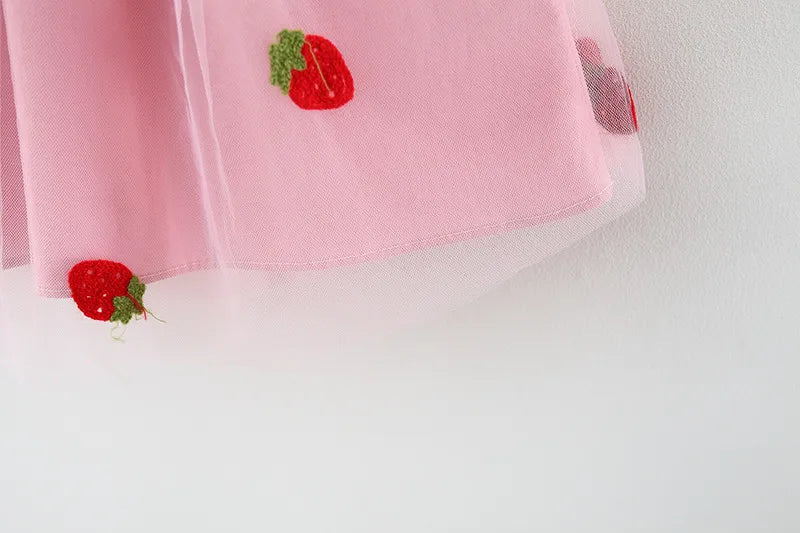Kids' fashion: White embroidered strawberry dress with a bow, light and breezy for summer.