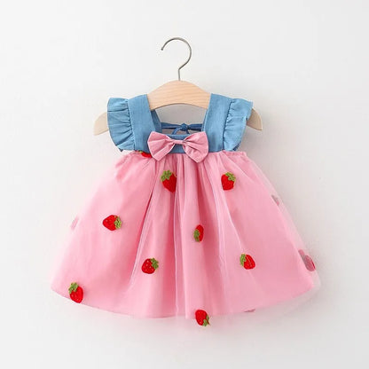 Infant wear: White summer dress for baby girl, detailed with red strawberry embroidery and a bow.
