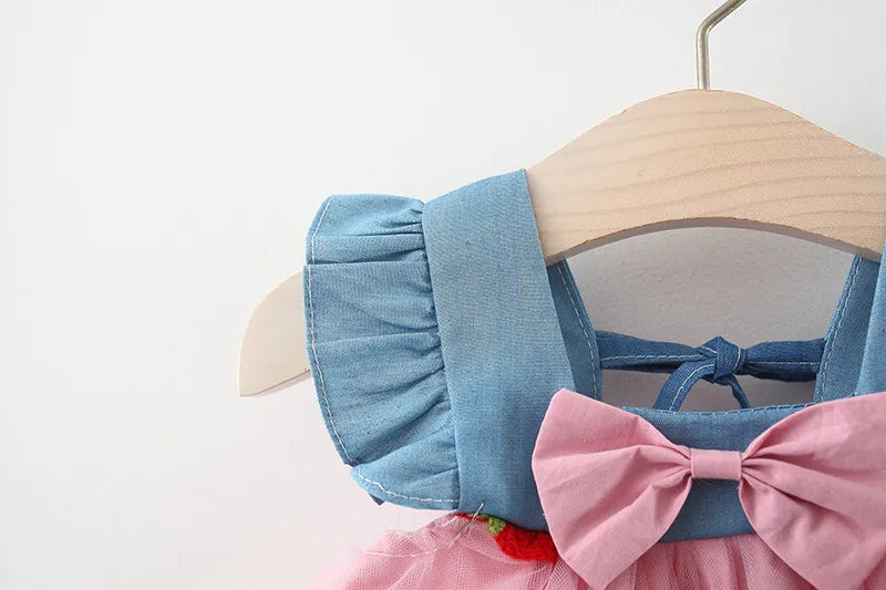 Elegant white polyester dress for young girls, featuring strawberry embroidery and a delicate bow design.