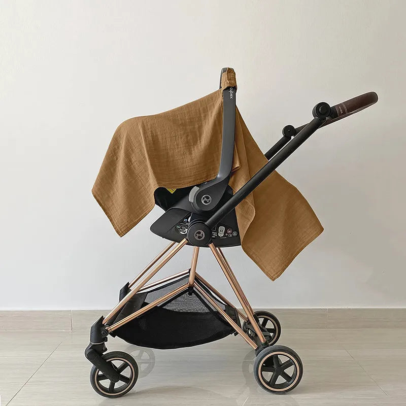 Closeup of gray breathable cotton fabric on a baby stroller sun shade cover, soft texture.