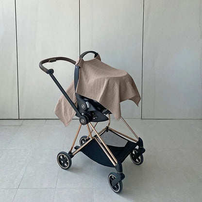 Green baby stroller with sun shade deployed, offering full sun and wind protection for baby.