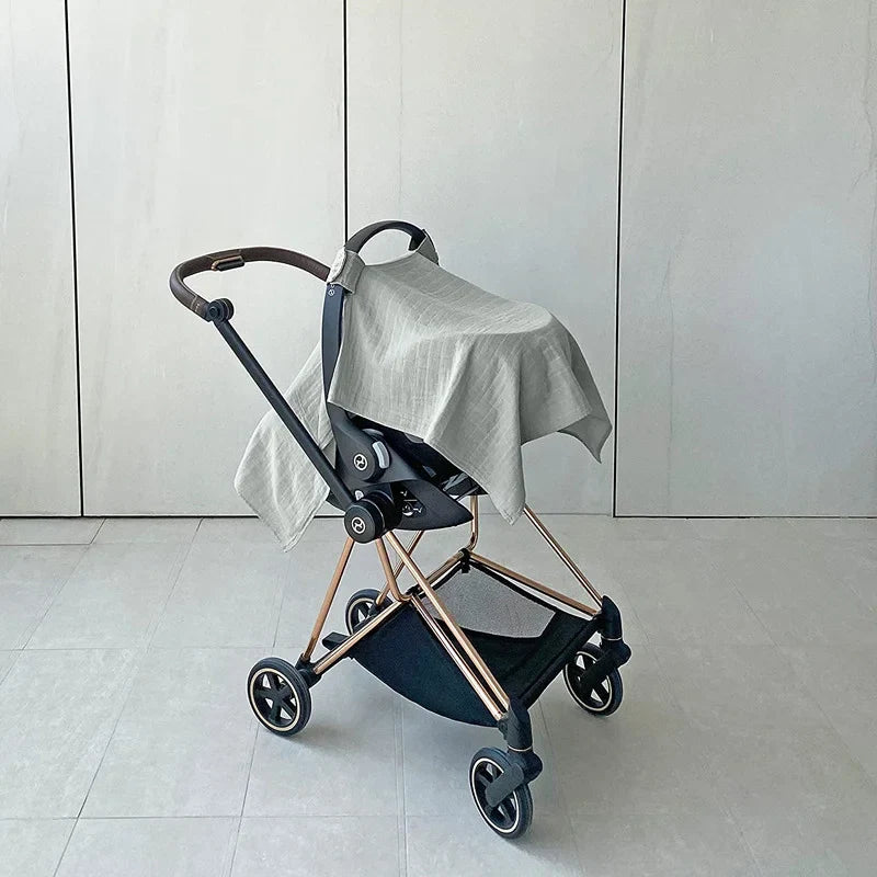 Blue baby car seat sun shade cover in use, demonstrating its breathable and protective design.