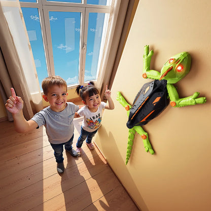 Orange wall climbing chameleon robot toy navigating a smooth surface, a rechargeable gadget for children.