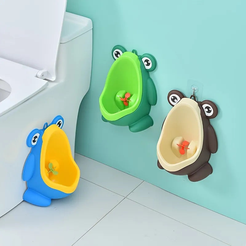 Green frog potty training urinal for boys with fun aim target, promoting toddler independence.