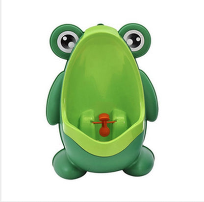 Toddler using a green froggy potty training urinal with spinning windmill, promoting independence.