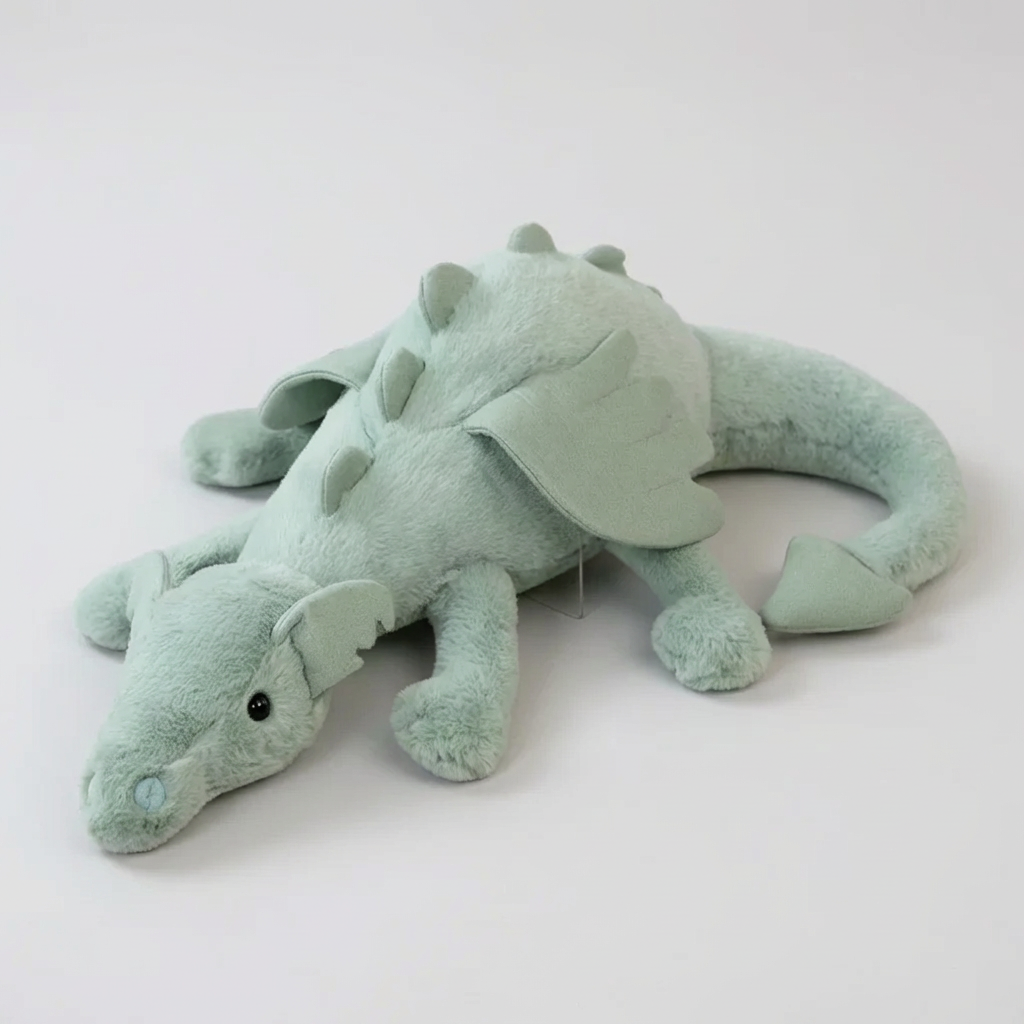 Green plush dragon toy, soft & cuddly for children's imaginative play. Stuffed animal gift, perfect for fantasy room decor.