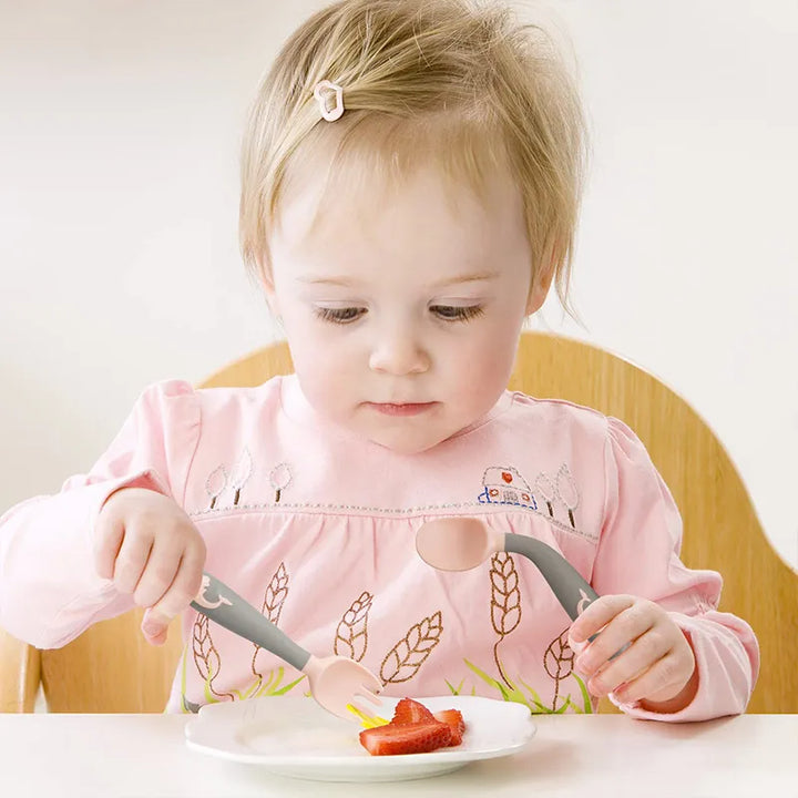 Pink silicone toddler fork, specifically for self-feeding training. Baby-safe & flexible.