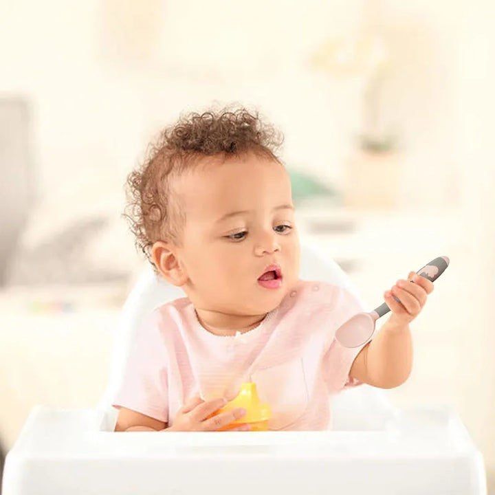 Baby self-feeding utensils: green silicone spoon & fork. Soft, safe, and easy for toddlers.