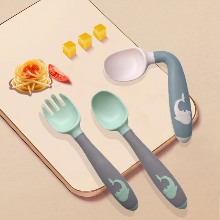 Silicone training spoon in green for babies. Develops self-feeding skills, features soft tip.
