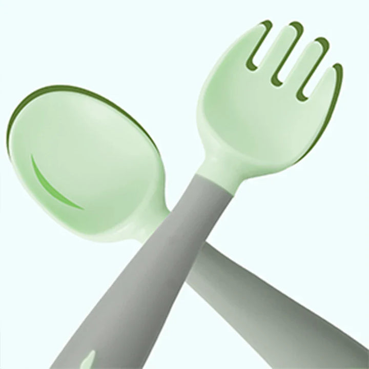 Full set of green & pink baby silicone training utensils for self-feeding. Soft & durable.