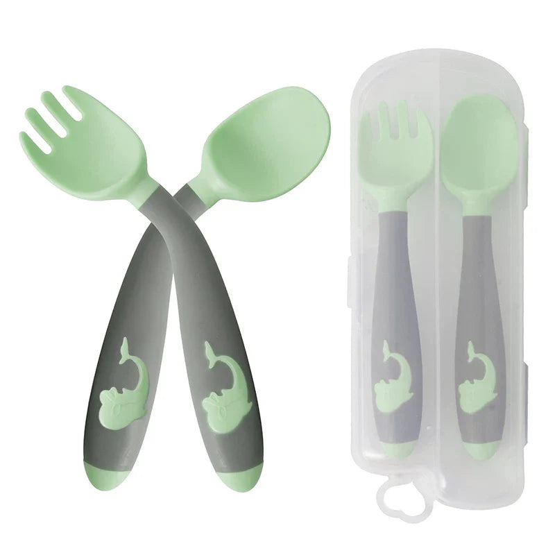 Baby self-feeding set with green & pink silicone training utensils. Soft, baby-safe material.