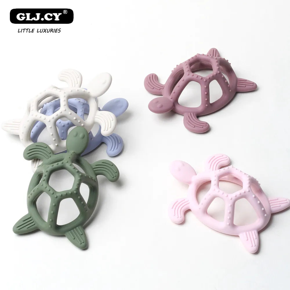 Baby chewing on a green silicone turtle teether, promoting healthy oral development