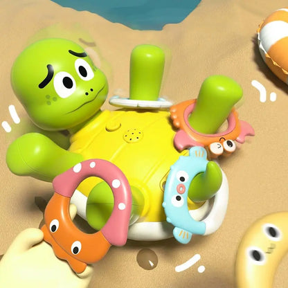 Toddler hand reaching for a spinning and squirting water turtle bath toy, ideal for water play.