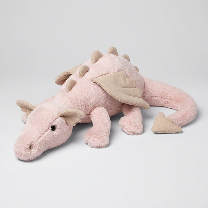 Close-up of a vibrant green dragon plush toy with intricate wings, a magical stuffed animal for children.