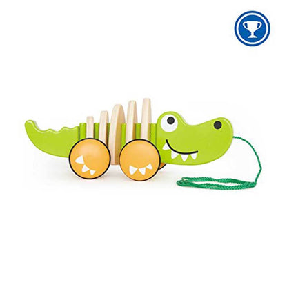 Toddler's wooden walk-a-long crocodile toy, brightly painted green, encourages early walking skills.