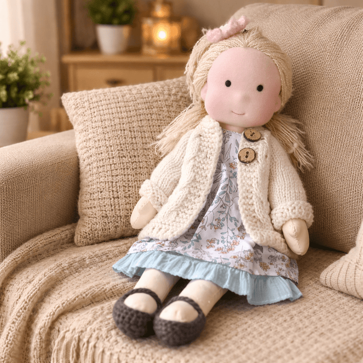 Artisanal Waldorf doll, a cuddly handmade cotton toy with natural appeal for kids.