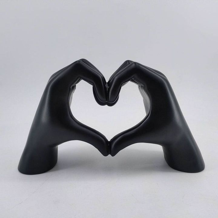 Artisanal handcrafted wood sculpture depicting heart hands. Modern home decor, unique love symbol art piece.