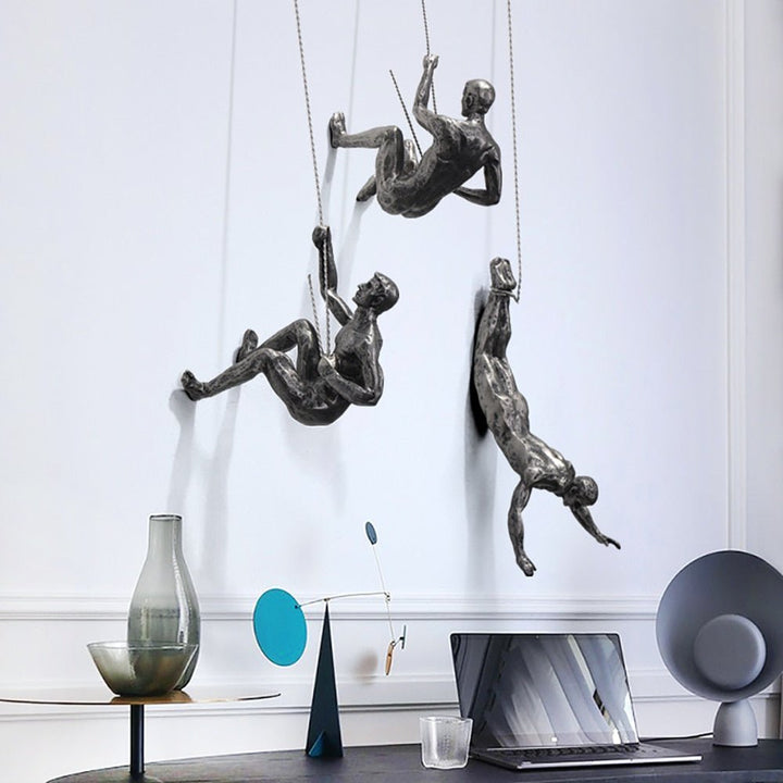 Unique wall sculpture: handcrafted climber figure, modern interior design art.