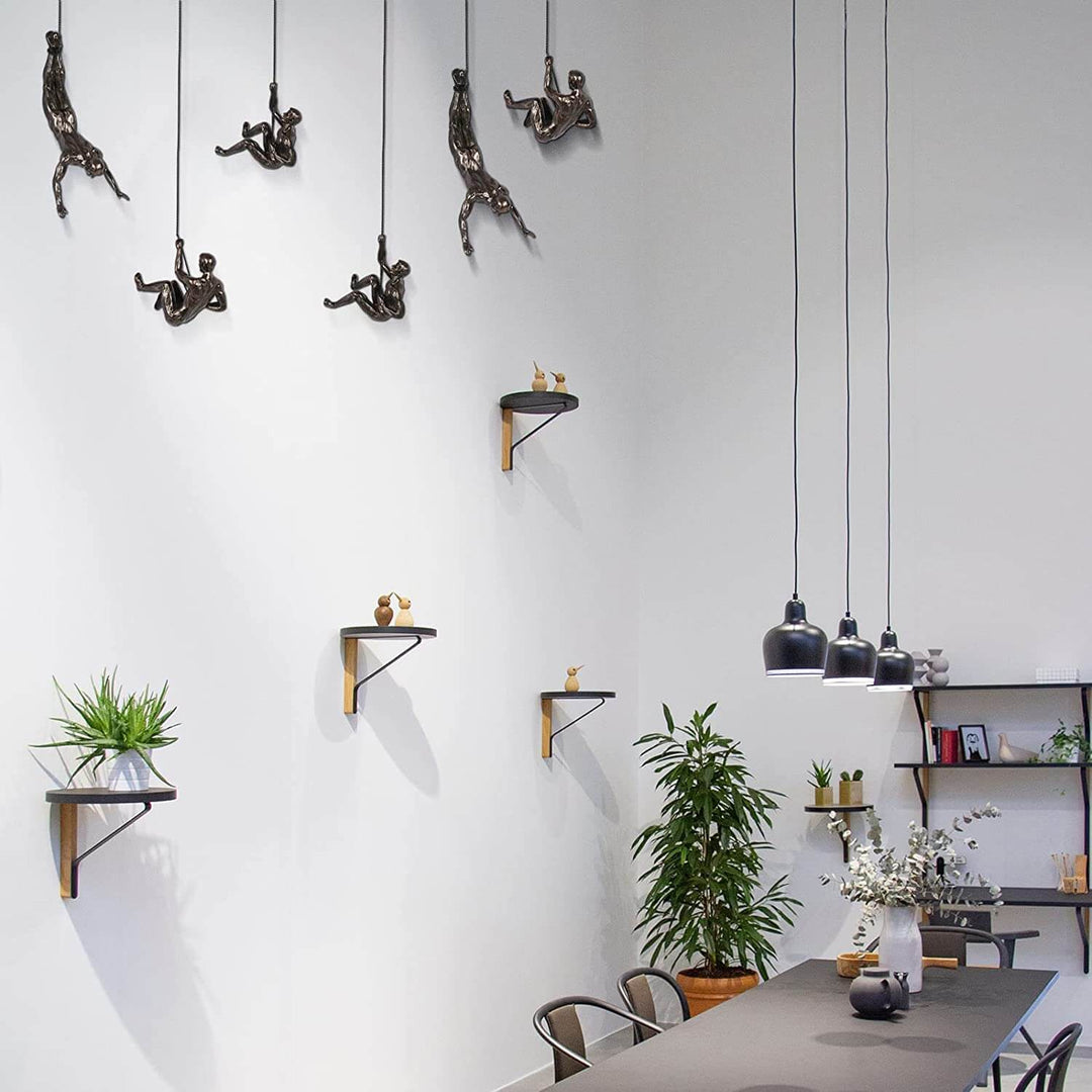 Dynamic climbing figure wall art, modern handmade sculpture for inspiring interiors.