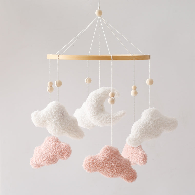 Cloud baby mobile hanging over a crib, a charming addition for calm and soothing baby room decor.