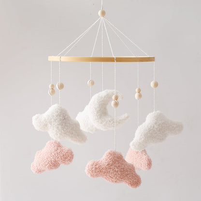 Cloud baby mobile hanging over a crib, a charming addition for calm and soothing baby room decor.