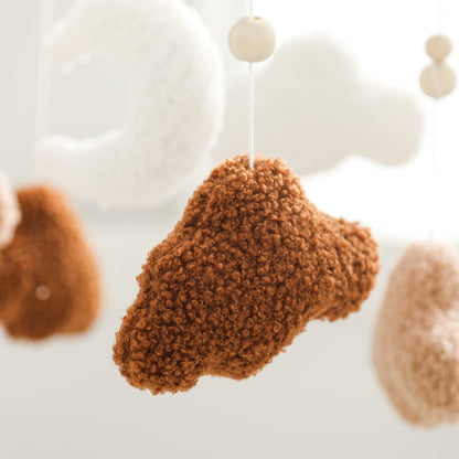 Neutral cloud mobile with gentle raindrops, designed to be a focal point in any baby's nursery.